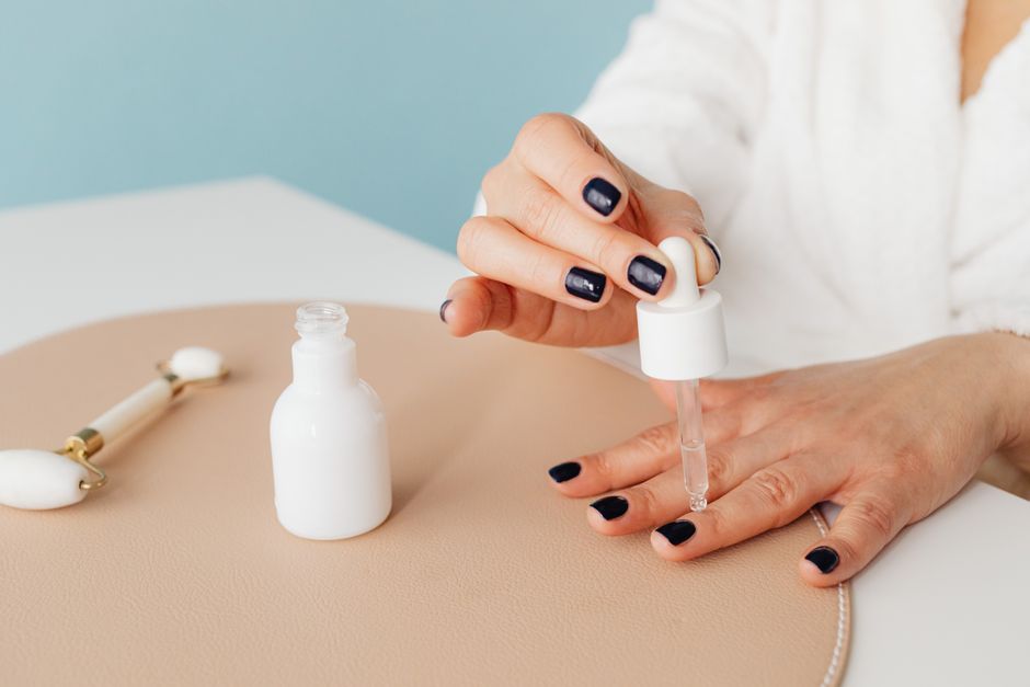 Applying cuticle oil as part of a daily nail care routine to maintain hydration.