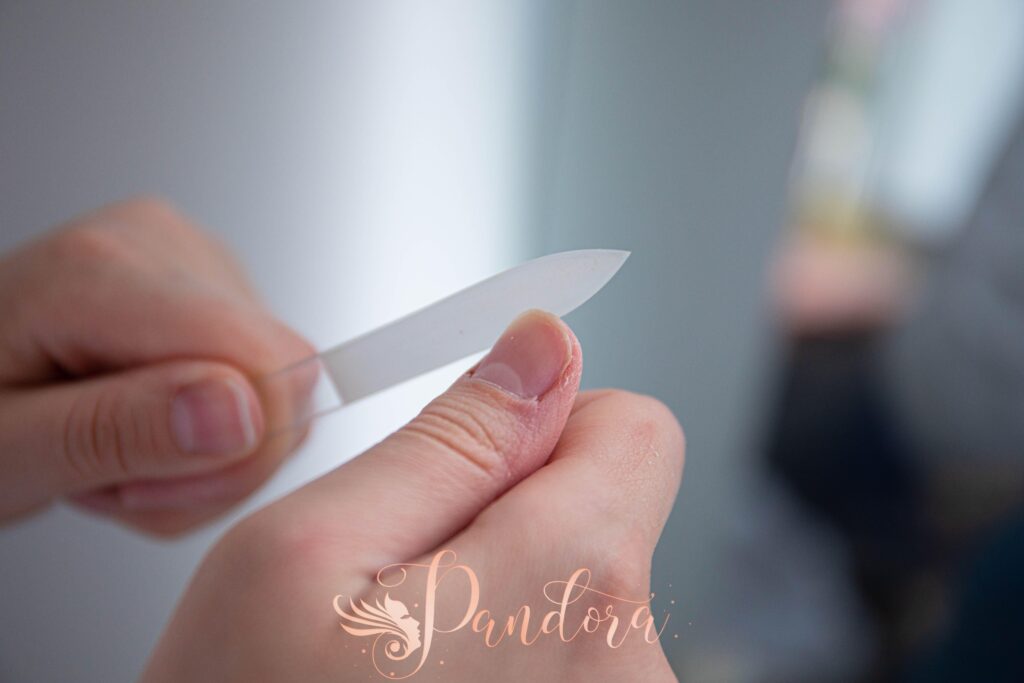 Applying cuticle oil during a nail cuticle care session at our Lafayette salon.
