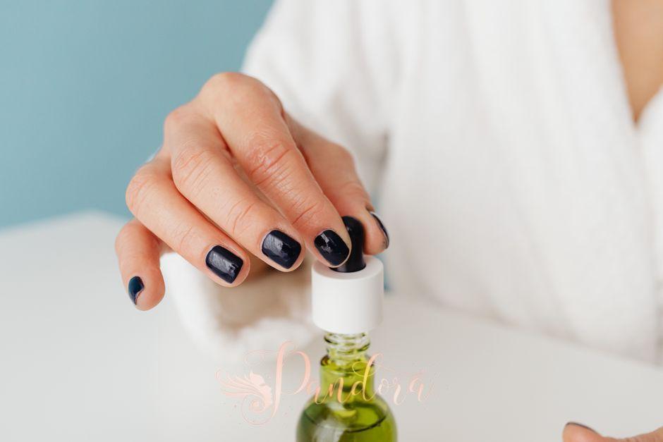 Applying cuticle oil during a nail cuticle care session at our Lafayette salon.