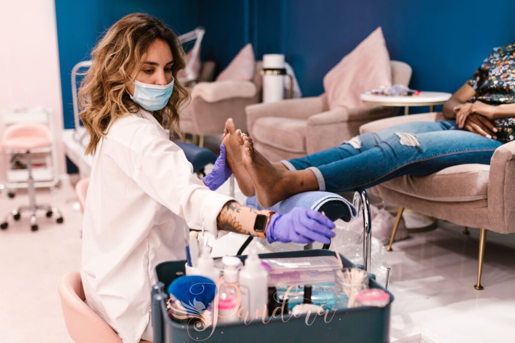 A beautician performs a pedicure on a client in a modern salon setting — Pandora Nail Spa, Lafayette, CA