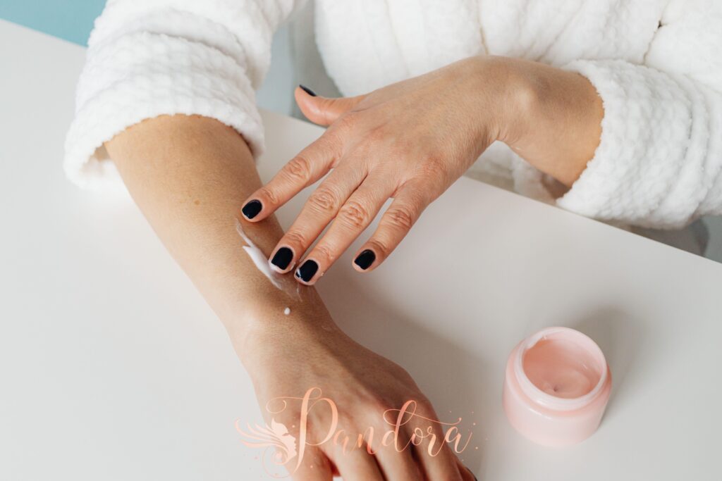 Applying cuticle oil for winter hydration at Pandora Nail Spa.