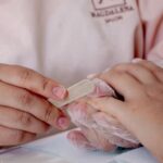 Close-up of a manicurist filing nails in a salon setting, highlighting attention to detail — Pandora Nail Spa, Lafayette, CA