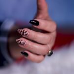 Close-up of a stylish hand with black and leopard print nail art — Pandora Nail Spa, Lafayette, CA