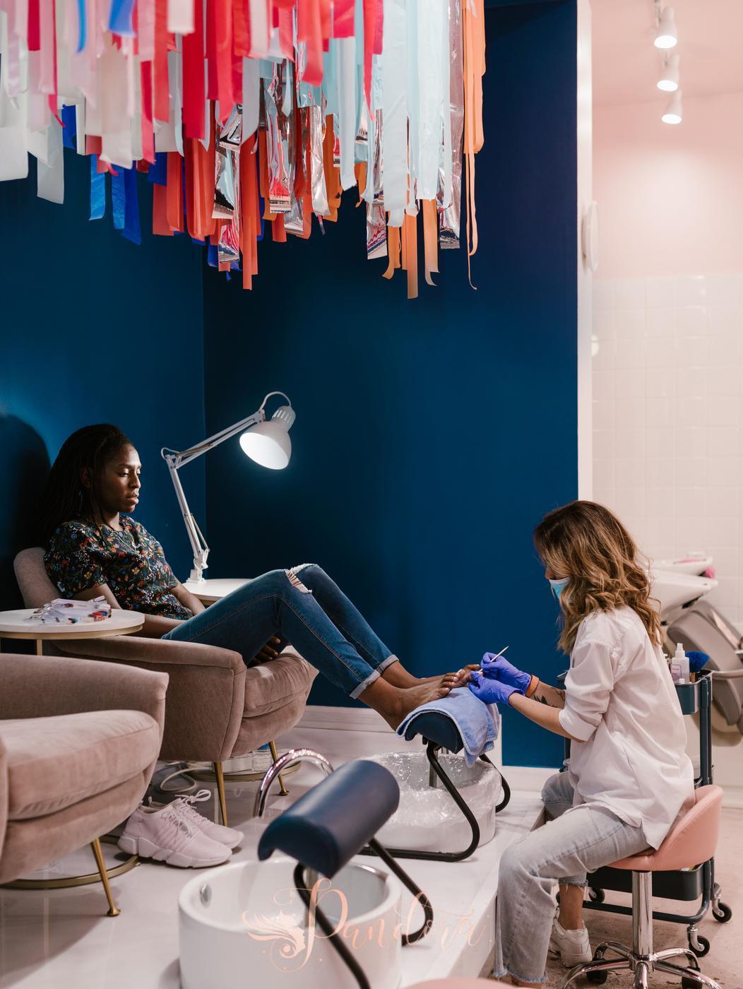 Woman enjoys a relaxing pedicure at a stylish beauty salon with vibrant decor — Pandora Nail Spa, Lafayette, CA