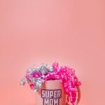 A festive Super Mom mug adorned with pink and silver ribbons on a pink background, perfect for Mothe — Pandora Nail Spa, Lafayette, CA