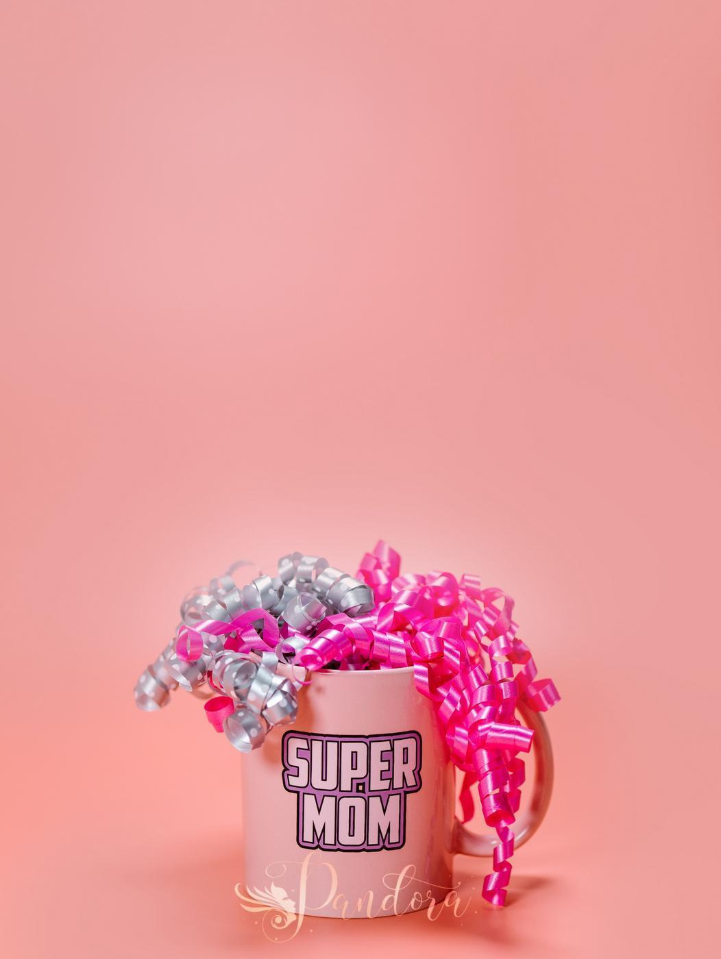 A festive Super Mom mug adorned with pink and silver ribbons on a pink background, perfect for Mothe — Pandora Nail Spa, Lafayette, CA
