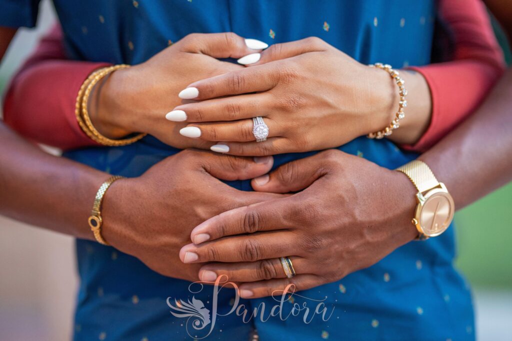 Intimate close-up shot of a couple's hands, showcasing elegant jewelry and engagement rings — Pandora Nail Spa, Lafayette, CA