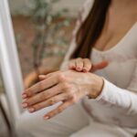 Close-up of a woman moisturizing her hands, focusing on self-care and beauty — Pandora Nail Spa, Lafayette, CA