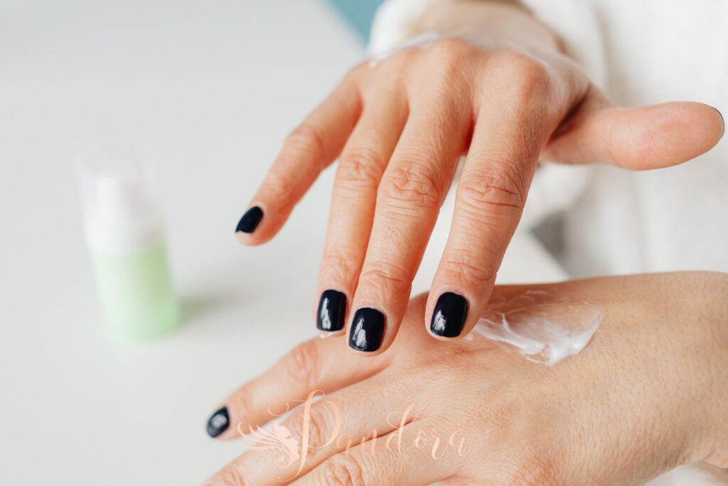 Close-up of a woman applying hand cream for moisturizing — Pandora Nail Spa, Lafayette, CA
