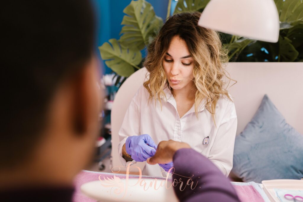 A woman providing a manicure service in a nail salon, showcasing self-care and professionalism — Pandora Nail Spa, Lafayette, CA